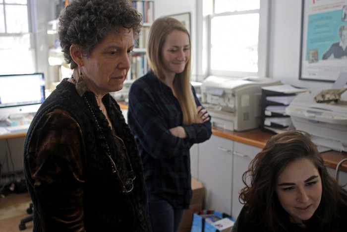 Laurie Kahn (left) looking at pictures with production assistant Riley Davis (center) and production coordinator Julia Hines. Photo: Sean Proctor/Boston Globe